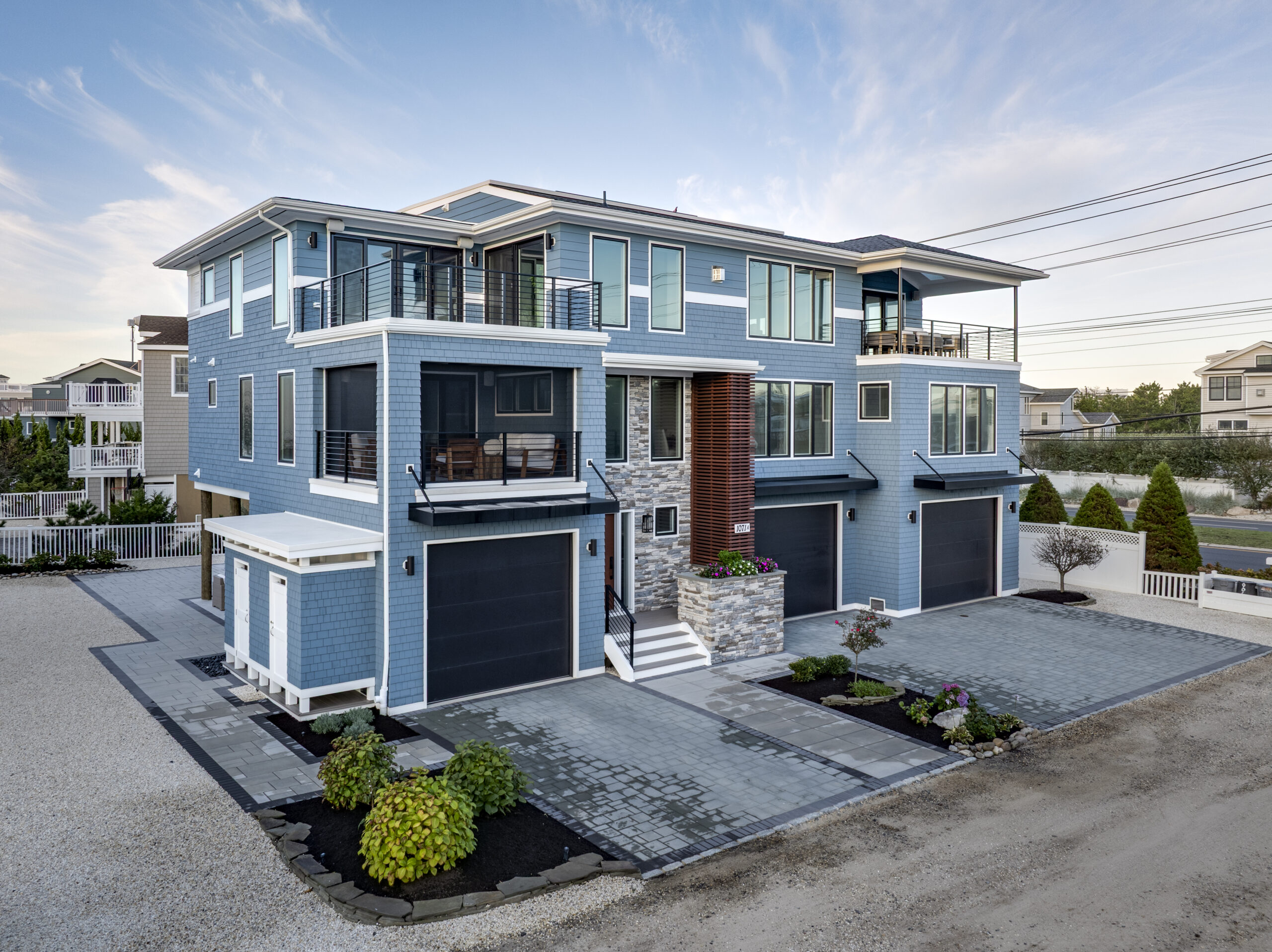 Exterior of a luxury custom home on LBI blending coastal palette and inspiration with modern design | Stonehenge Built | LBI Custom Home Builder