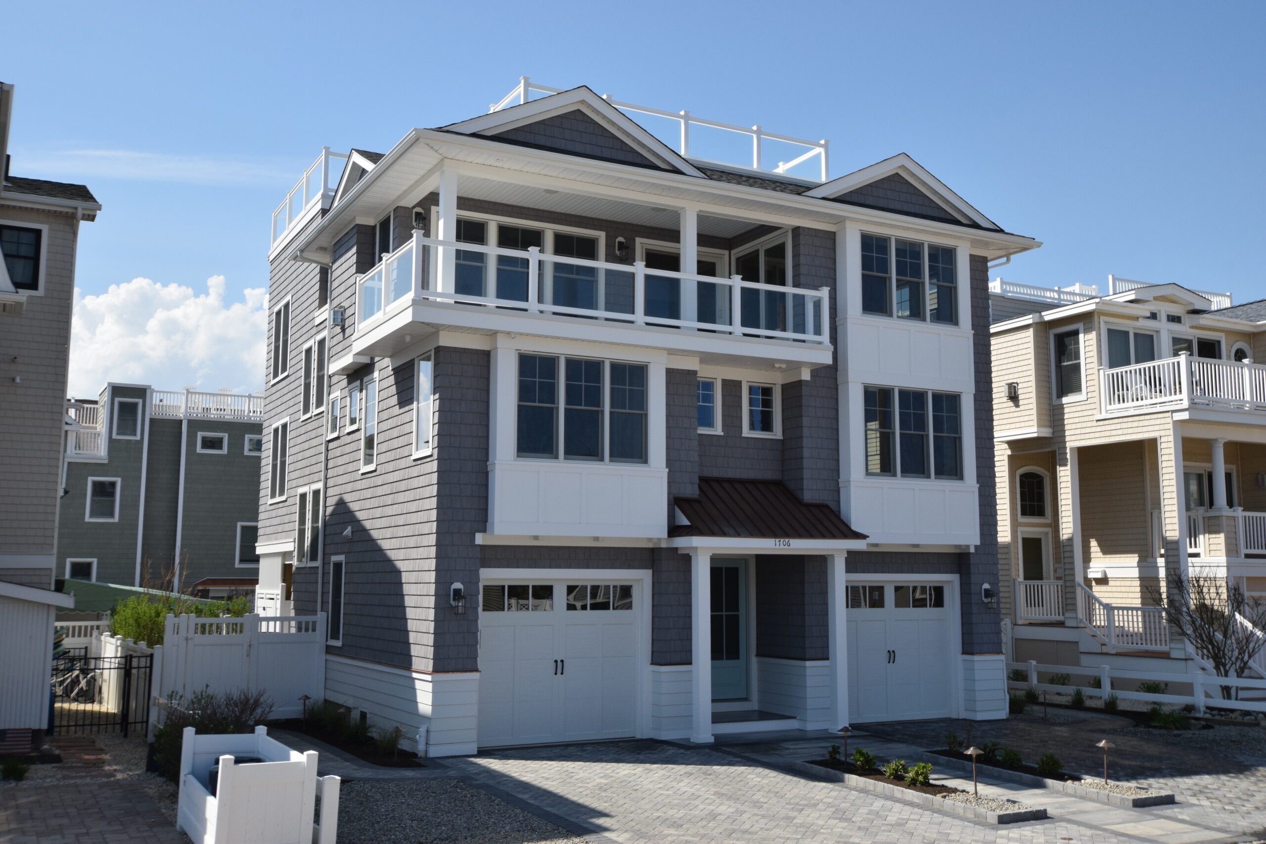 Exterior of a luxury custom home on LBI blending coastal palette and inspiration with modern design and two car garage | Stonehenge Built | LBI Custom Home Builder