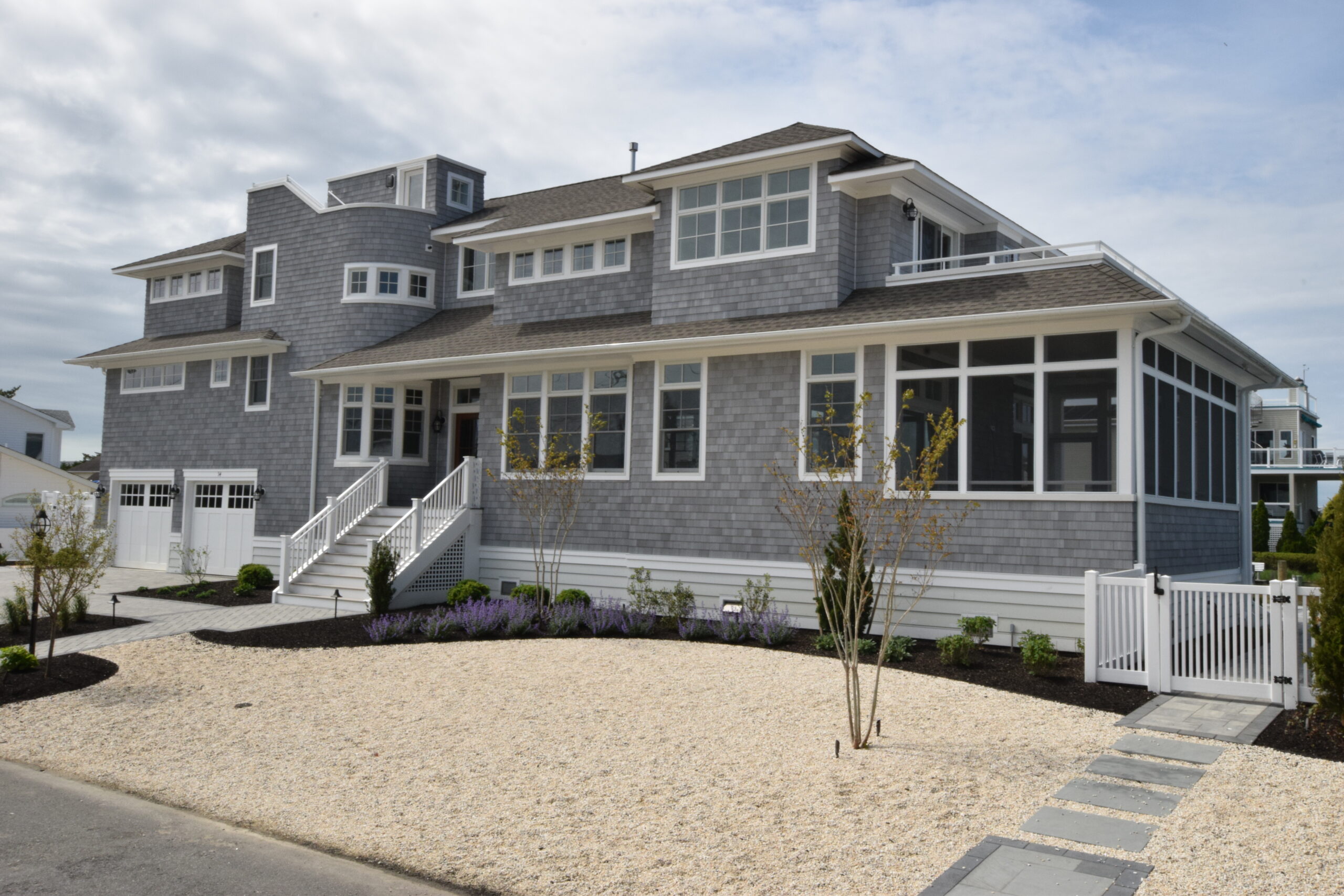 Exterior of a luxury custom home on LBI blending coastal palette and inspiration with modern design and two car garage | Stonehenge Built | LBI Custom Home Builder